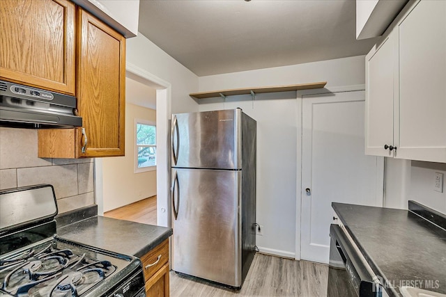 8 Macarthur Dr, Edison, NJ 08837 - kitchen featuring freestanding refrigerator, gas stove, dark countertops, under cabinet range hood, and light wood-type flooring