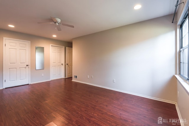 unfurnished bedroom with dark wood finished floors, visible vents, recessed lighting, and baseboards