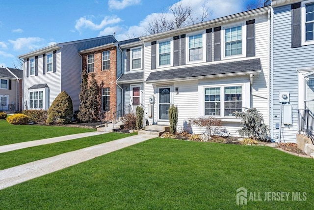 multi unit property featuring entry steps and a front yard