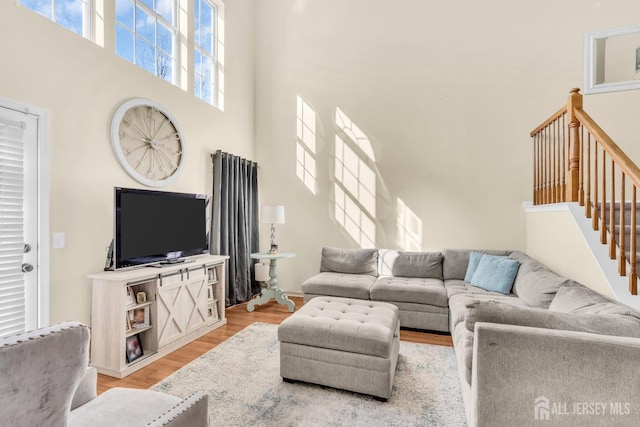 12 Jeremy Way, Old Bridge, NJ 08857 - living room featuring a high ceiling, light wood-style flooring, and stairway