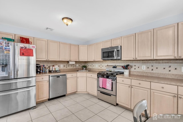 12 Jeremy Way, Old Bridge, NJ 08857 - kitchen featuring appliances with stainless steel finishes, light brown cabinetry, light tile patterned flooring, and light countertops