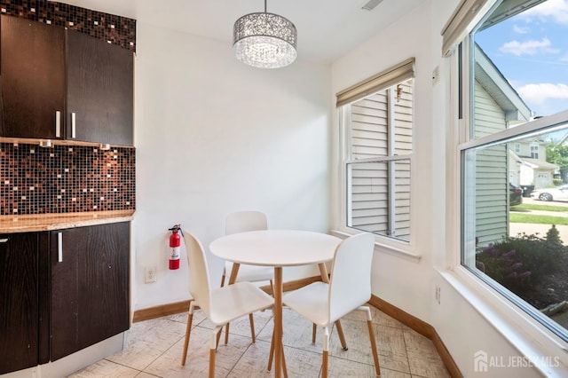 297 Kraemer Ct, East Brunswick, NJ 08816 - dining area with a chandelier and baseboards