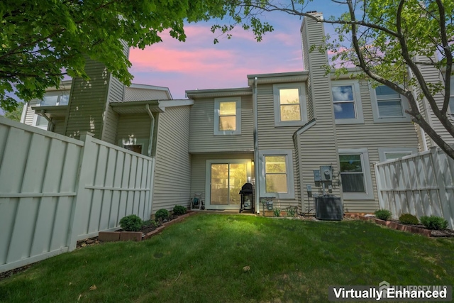 297 Kraemer Ct, East Brunswick, NJ 08816 - back of house at dusk with a chimney and central AC unit