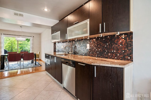 297 Kraemer Ct, East Brunswick, NJ 08816 - kitchen with stainless steel dishwasher, a sink, decorative backsplash, dark brown cabinetry, and light stone counters