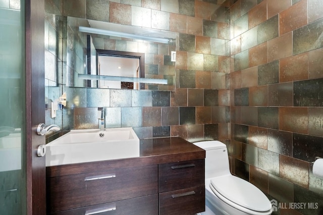 297 Kraemer Ct, East Brunswick, NJ 08816 - half bathroom featuring tile walls, toilet, and vanity