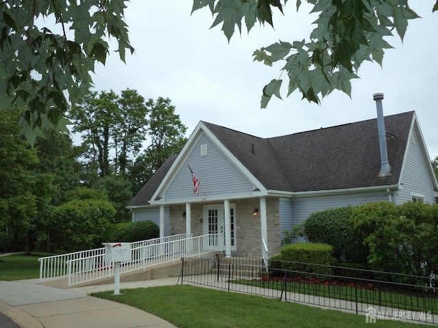 297 Kraemer Ct, East Brunswick, NJ 08816 - view of front of house with a fenced front yard, stone siding, covered porch, and roof with shingles