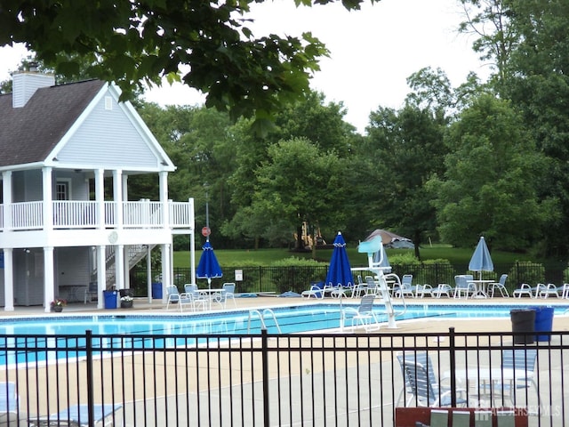 297 Kraemer Ct, East Brunswick, NJ 08816 - community pool with fence, stairs, a patio, and view of scattered trees