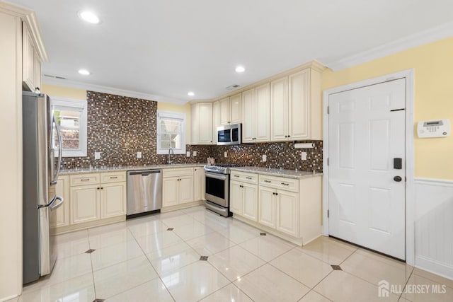 55 Nottingham Dr, Old Bridge, NJ 08857 - kitchen with cream cabinets, appliances with stainless steel finishes, healthy amount of natural light, tasteful backsplash, and crown molding