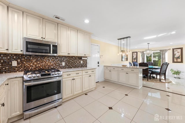 55 Nottingham Dr, Old Bridge, NJ 08857 - kitchen with appliances with stainless steel finishes, cream cabinetry, tasteful backsplash, a chandelier, and crown molding