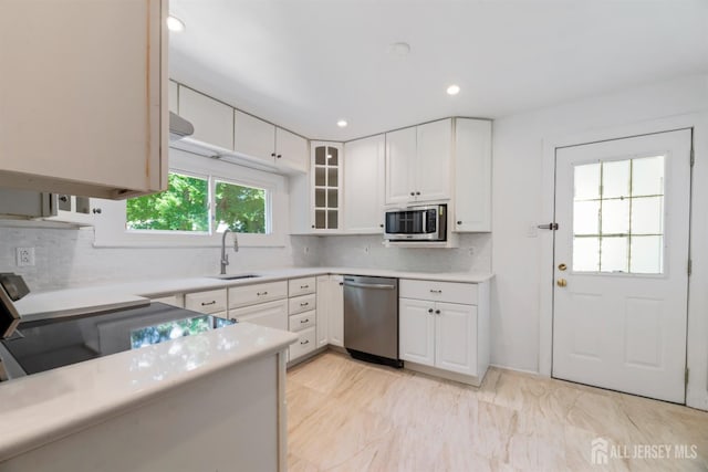 299 Riva Ave, East Brunswick, NJ 08850 - kitchen featuring appliances with stainless steel finishes, a sink, light countertops, tasteful backsplash, and recessed lighting