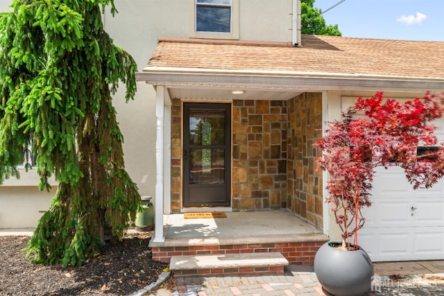 299 Riva Ave, East Brunswick, NJ 08850 - property entrance featuring stucco siding, a garage, and roof with shingles