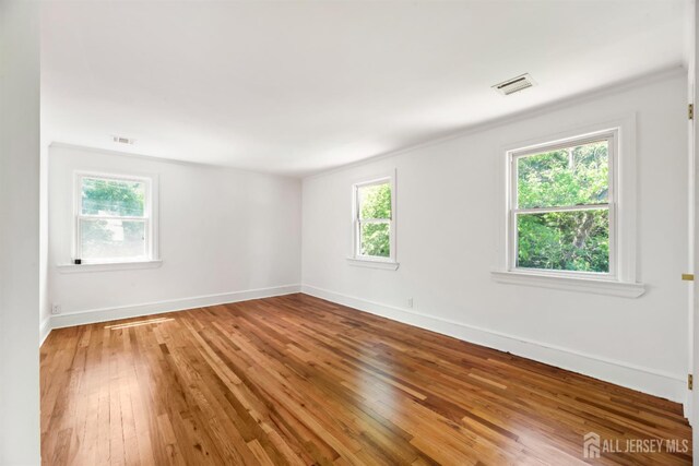 299 Riva Ave, East Brunswick, NJ 08850 - empty room with wood-type flooring, baseboards, and crown molding