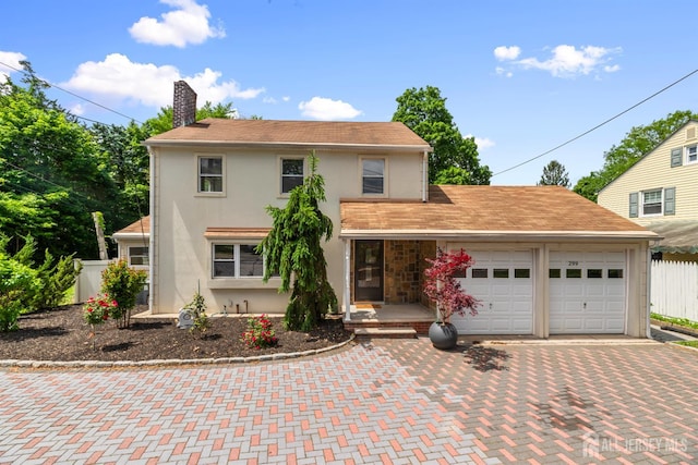 299 Riva Ave, East Brunswick, NJ 08850 - traditional-style home with stucco siding, a chimney, a garage, and decorative driveway