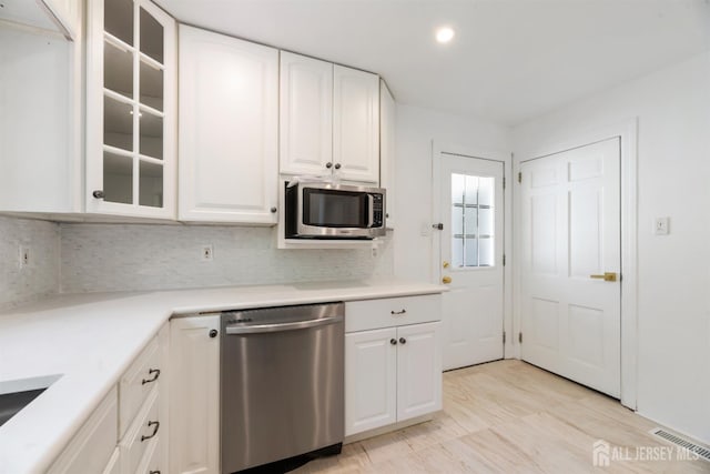 299 Riva Ave, East Brunswick, NJ 08850 - kitchen with appliances with stainless steel finishes, glass insert cabinets, decorative backsplash, white cabinets, and recessed lighting