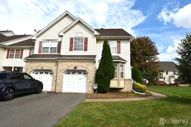 view of front property with a garage and a front lawn