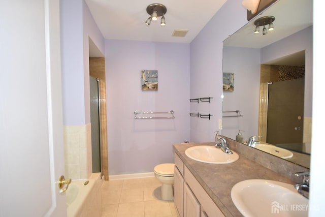 full bathroom with tile patterned floors, vanity, independent shower and bath, and toilet