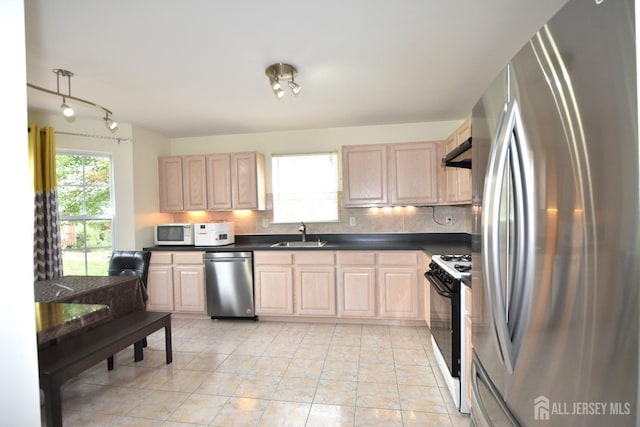 kitchen featuring sink, light tile patterned floors, light brown cabinetry, tasteful backsplash, and stainless steel appliances