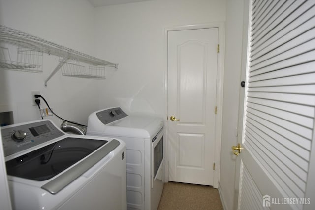 laundry area with separate washer and dryer