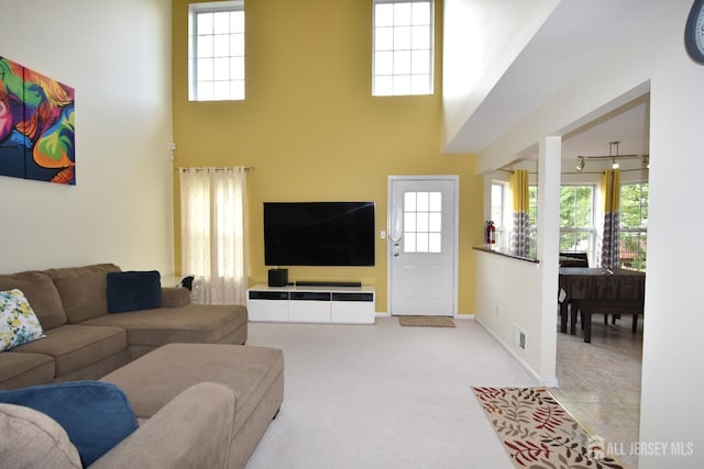 tiled living room with a towering ceiling