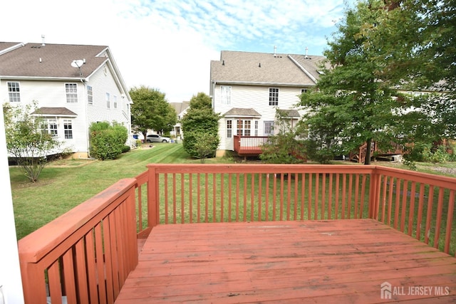 wooden deck with a lawn