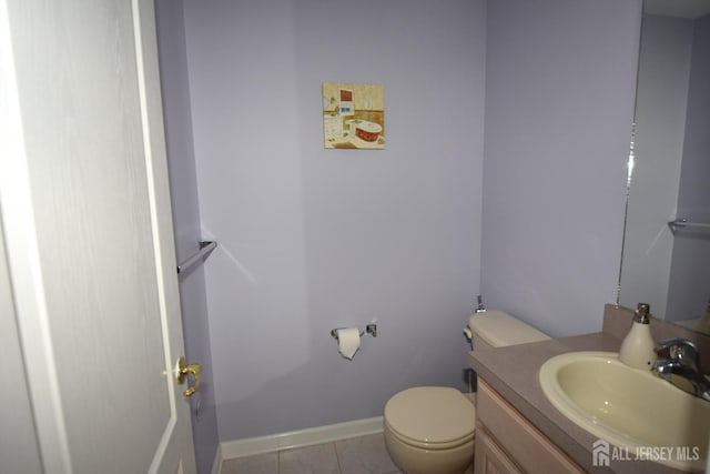 bathroom featuring tile patterned floors, vanity, and toilet