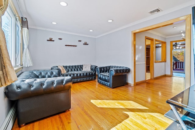 living room featuring recessed lighting, baseboard heating, visible vents, and wood finished floors