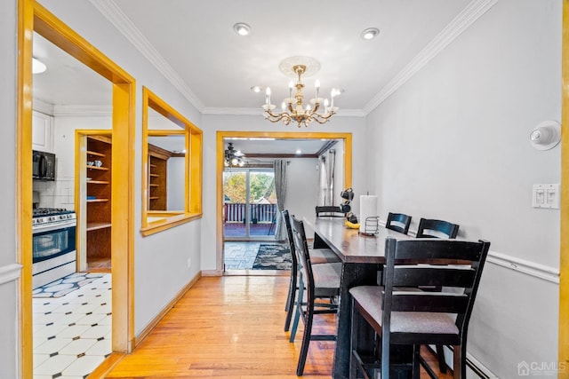 dining area with recessed lighting, ornamental molding, light wood-type flooring, baseboards, and a notable chandelier