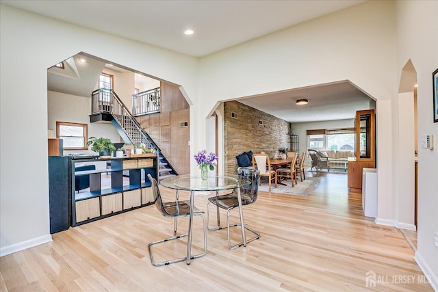 207 Dellwood Rd, Metuchen, NJ 08840 - dining room with wood finished floors, stairs, arched walkways, baseboards, and a high ceiling