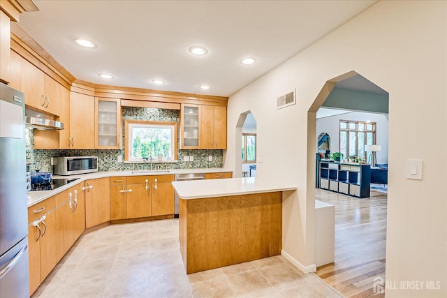 207 Dellwood Rd, Metuchen, NJ 08840 - kitchen featuring stainless steel appliances, a sink, arched walkways, light countertops, and recessed lighting