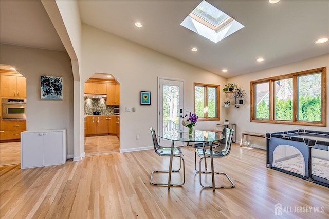 207 Dellwood Rd, Metuchen, NJ 08840 - dining room featuring lofted ceiling, light wood-type flooring, arched walkways, recessed lighting, and a skylight