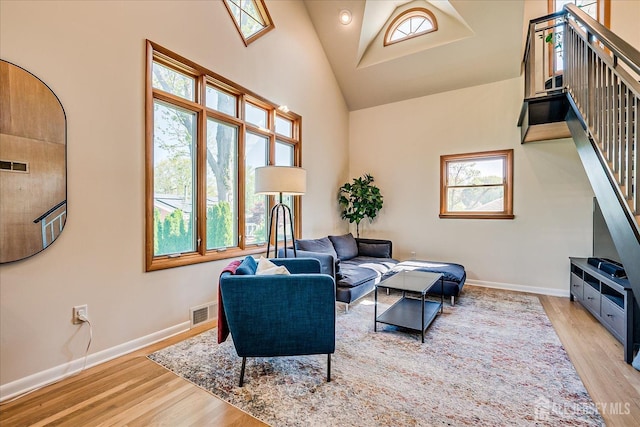 207 Dellwood Rd, Metuchen, NJ 08840 - living room featuring light wood-style floors, high vaulted ceiling, and baseboards