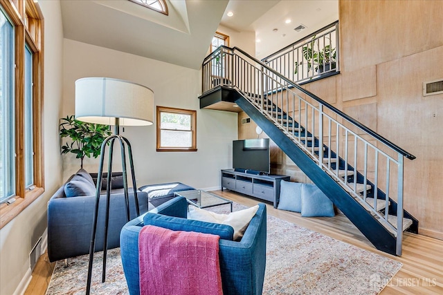 207 Dellwood Rd, Metuchen, NJ 08840 - living room with wood finished floors, stairs, a high ceiling, and baseboards