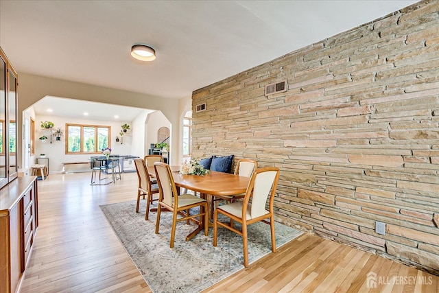 207 Dellwood Rd, Metuchen, NJ 08840 - dining area with arched walkways and light wood-style floors
