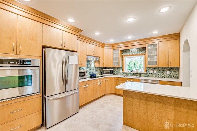 207 Dellwood Rd, Metuchen, NJ 08840 - kitchen with stainless steel appliances, a sink, light countertops, glass insert cabinets, and recessed lighting