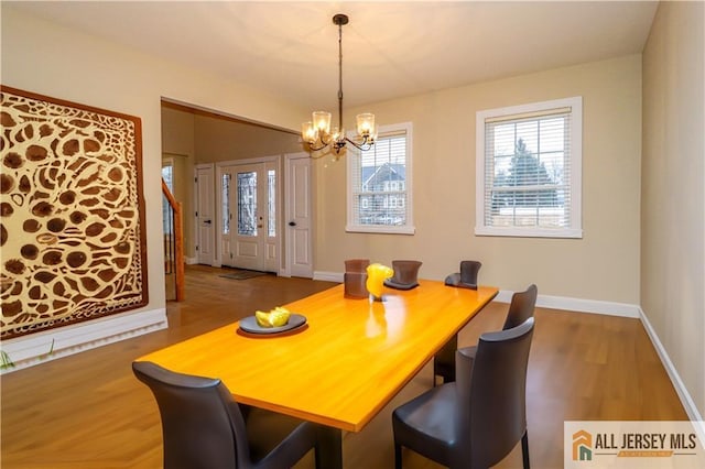 4 Kristina Ct, East Brunswick, NJ 08816 - dining room featuring a chandelier, wood finished floors, and baseboards