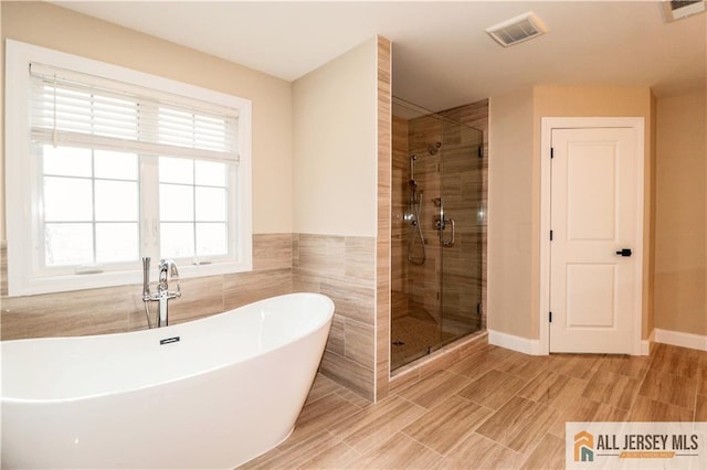 4 Kristina Ct, East Brunswick, NJ 08816 - bathroom featuring a shower stall, a freestanding bath, and baseboards