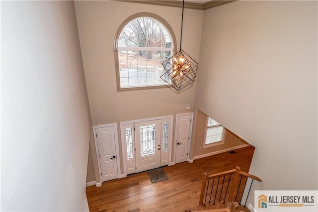 4 Kristina Ct, East Brunswick, NJ 08816 - foyer featuring a chandelier, healthy amount of natural light, a high ceiling, wood finished floors, and baseboards