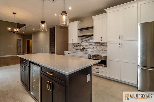 4 Kristina Ct, East Brunswick, NJ 08816 - kitchen with appliances with stainless steel finishes, wine cooler, white cabinetry, tasteful backsplash, and a kitchen island
