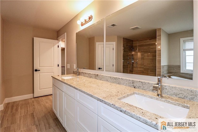 4 Kristina Ct, East Brunswick, NJ 08816 - bathroom featuring a tile shower, double vanity, and baseboards