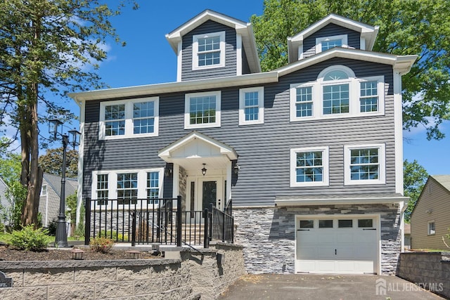 831 W Inman Ave, Rahway, NJ 07065 - view of front of house with stone siding, a garage, and driveway