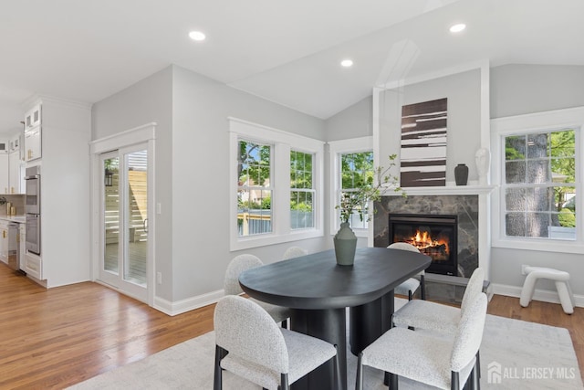 831 W Inman Ave, Rahway, NJ 07065 - dining area featuring lofted ceiling, plenty of natural light, a fireplace, light wood finished floors, and recessed lighting