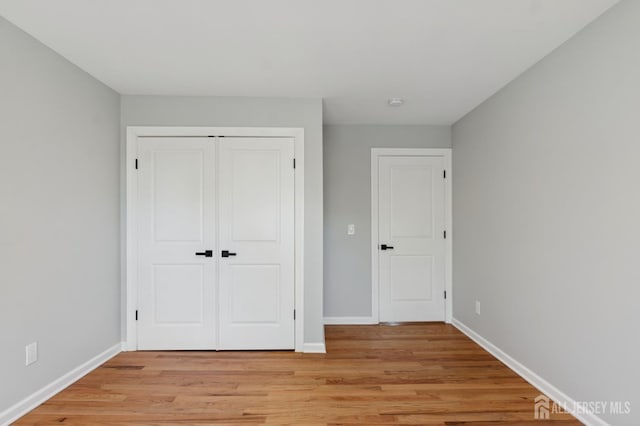 831 W Inman Ave, Rahway, NJ 07065 - unfurnished bedroom featuring light wood finished floors, a closet, and baseboards