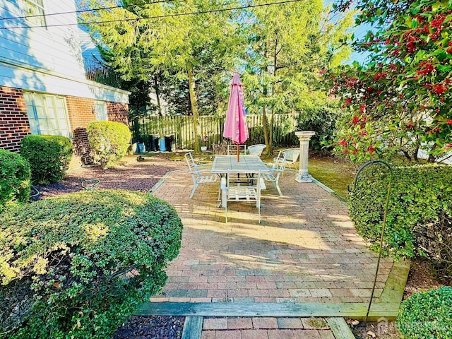 view of patio with fence and outdoor dining area