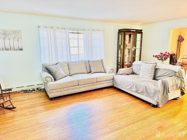 living area featuring ornamental molding, a baseboard heating unit, baseboards, and wood finished floors