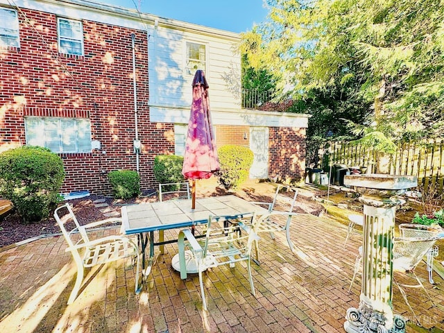 view of patio / terrace featuring outdoor dining area and fence