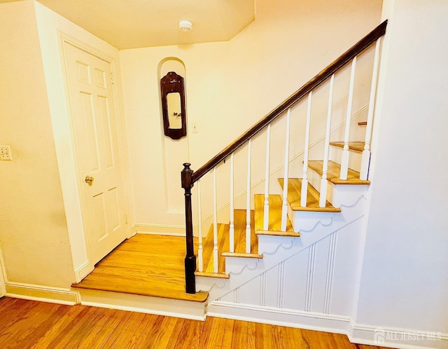 stairs featuring baseboards and wood finished floors