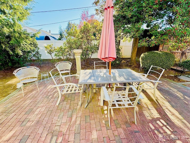 view of patio / terrace with outdoor dining space and fence