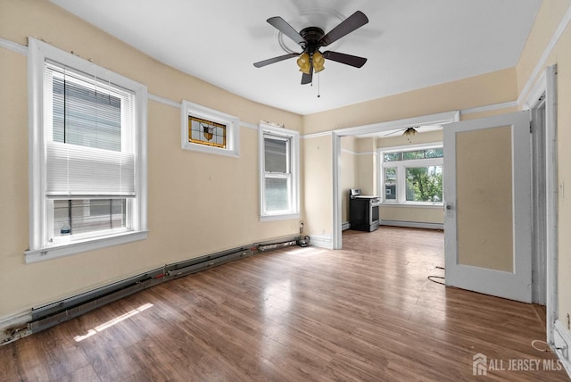 52 Wade St, Jersey City, NJ 07305 - spare room featuring ceiling fan, a baseboard heating unit, and wood finished floors