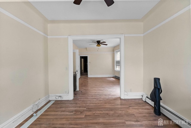 52 Wade St, Jersey City, NJ 07305 - empty room featuring ceiling fan, wood finished floors, and a baseboard heating unit