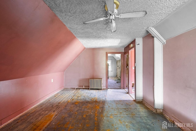 52 Wade St, Jersey City, NJ 07305 - additional living space featuring radiator heating unit, a textured ceiling, a ceiling fan, and lofted ceiling